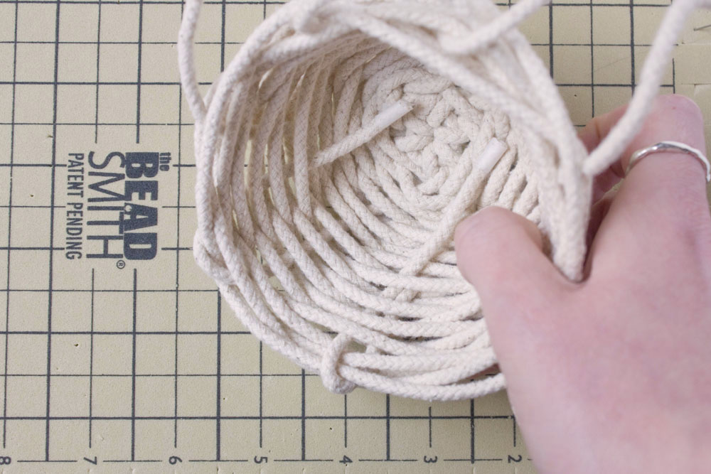 DIY Rope Basket Tutorial The stake that finish on the inside are brought over the top to the inside and also woven through