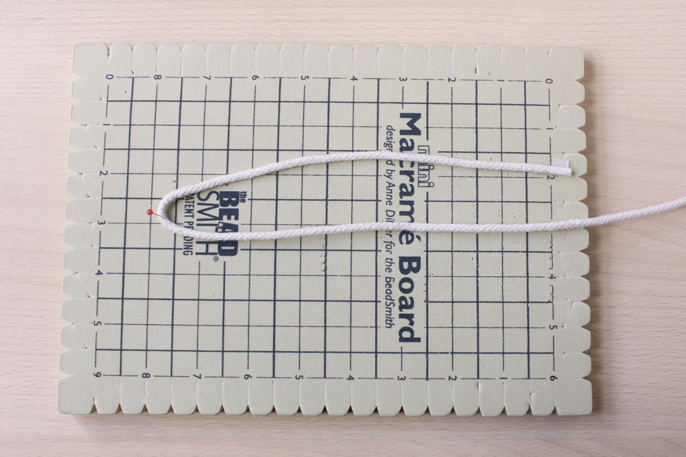 DIY Rope Basket Tutorial length of rope folded in half on a macrame board