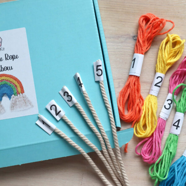 Macrame rope rainbow kit image, showing the open kit box with the neatly numbered ropes and yarns laid on top.