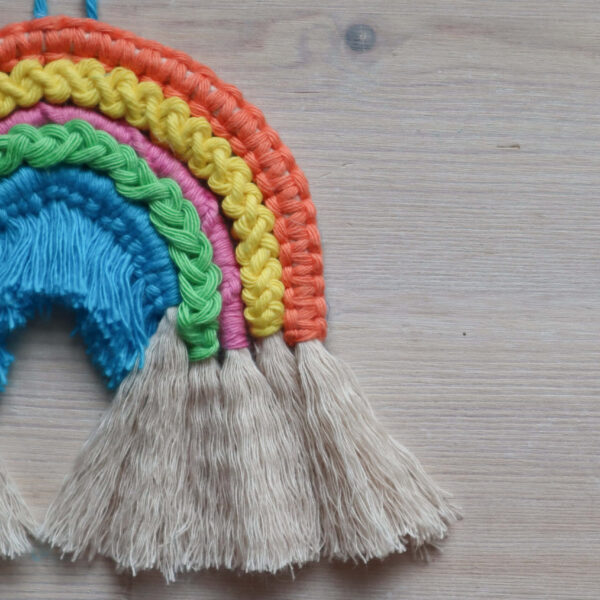Macrame rope rainbow kit image, showing a finished rainbow close up, with the five different macrame knots.
