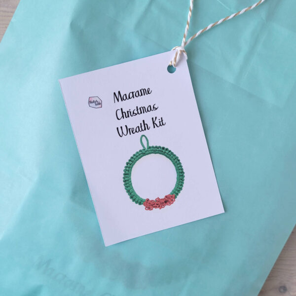 macrame Christmas wreath kit packaged in a blue bag with a hanging label