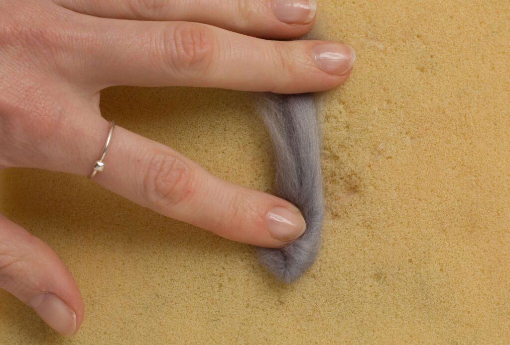 Needle Felt Bunny Rabbit Tutorial A small piece of grey roving, with the sides and tips folded in to create a simple ear shape
