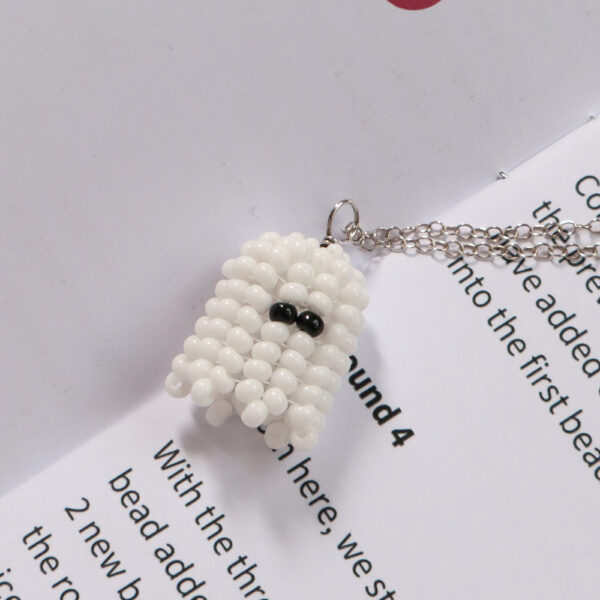Beaded ghost on a an open printed pattern