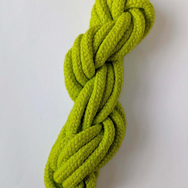 A skein of neon green 10mm macrame cord on a white background