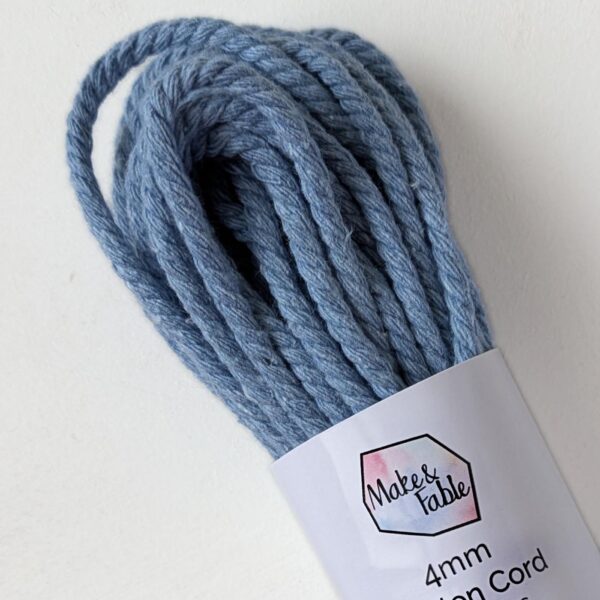 a bundle of 4mm macrame cord in a light denim blue