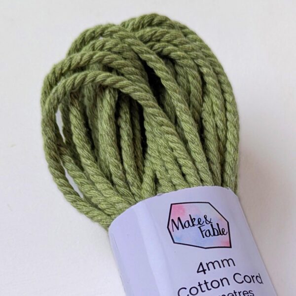Close up of a bundle of 4mm macrame cord in a sage green