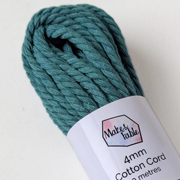 Close up of a bundle of 4mm macrame cord in teal