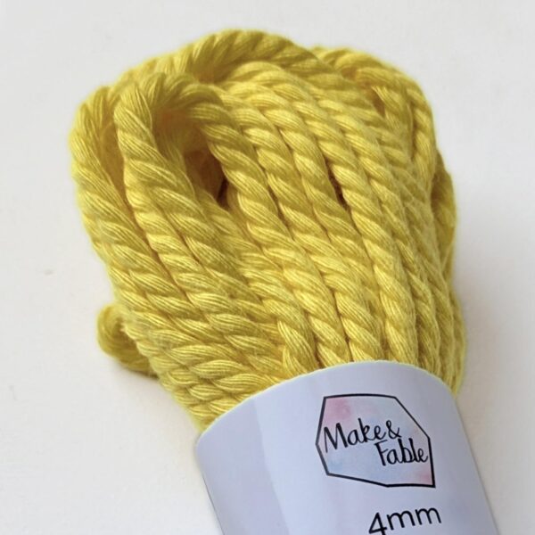 Close up of a bundle of 4mm macrame cord in a banana yellow