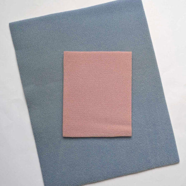 a small pink beading mat on top of a large blue beading mat