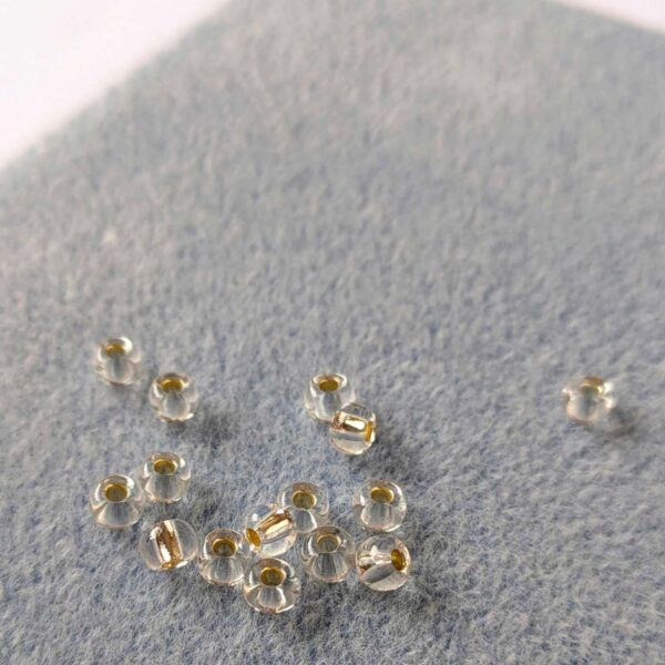 close up of beads on a blue flocked beading mat