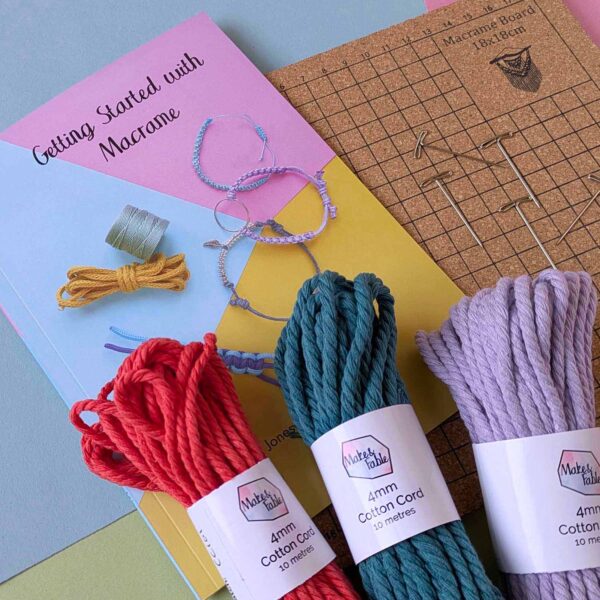 Macrame starter kit with 3 bundles of colourful cotton 4mm macrame cord, a cork board with t-pin and a getting started with macrame book