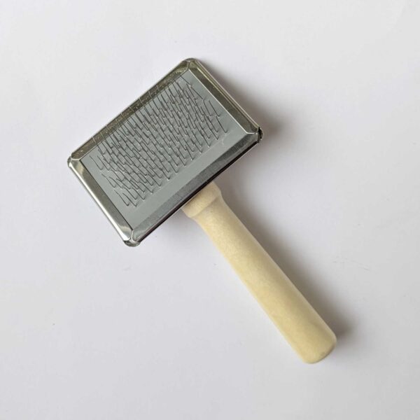 a small macrame brush